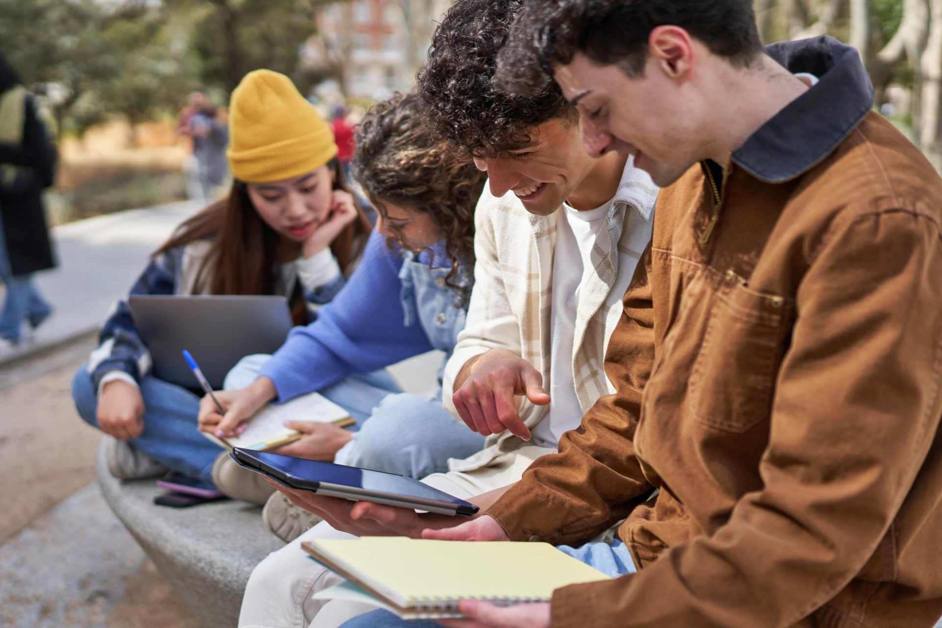 diverse-friends-collaborate-campus-project-sharing-laptops-ideas